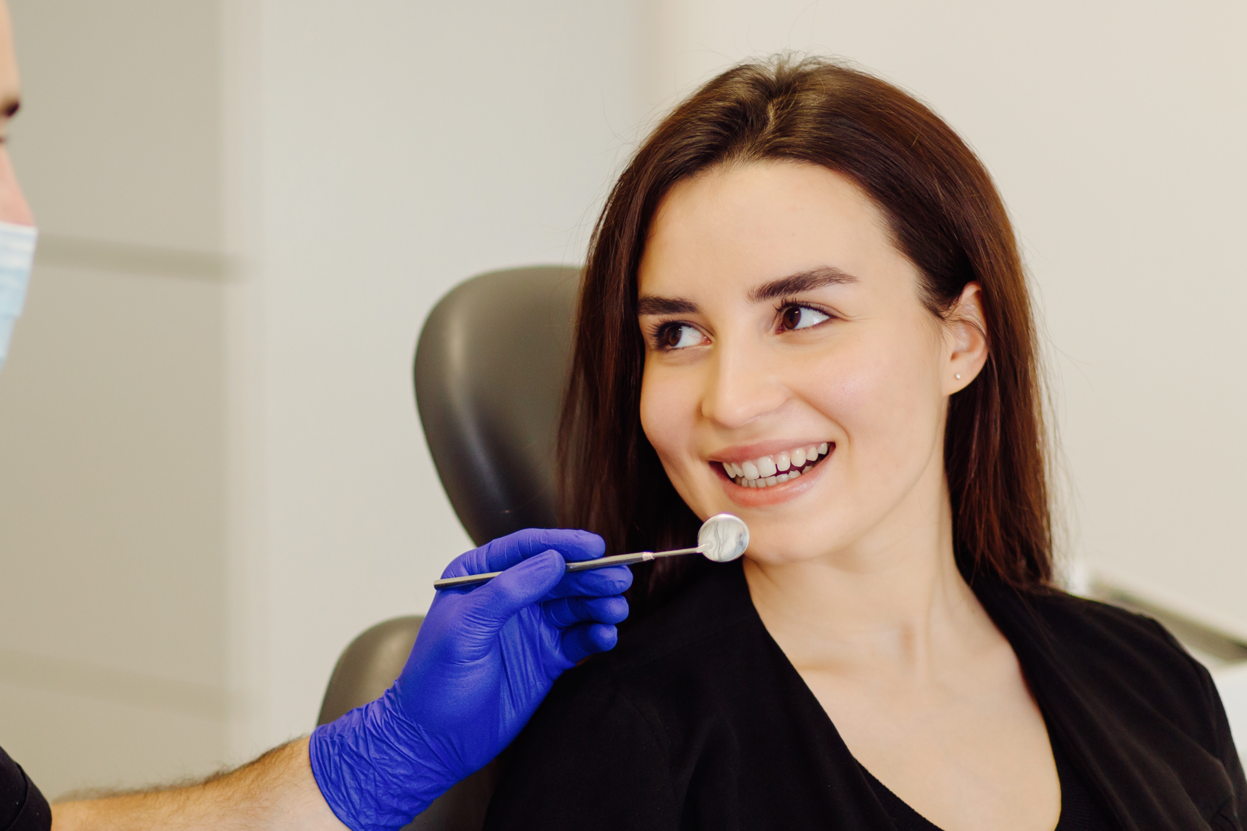 Dentist performing a gentle dental exam for an anxious patient during a comfortable visit in Erie, PA