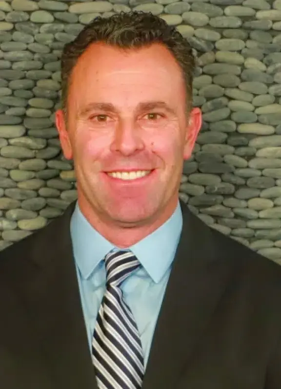 Dr. Kevin R. Sambuchino, DMD, smiling in professional headshot for Erie dental practice.